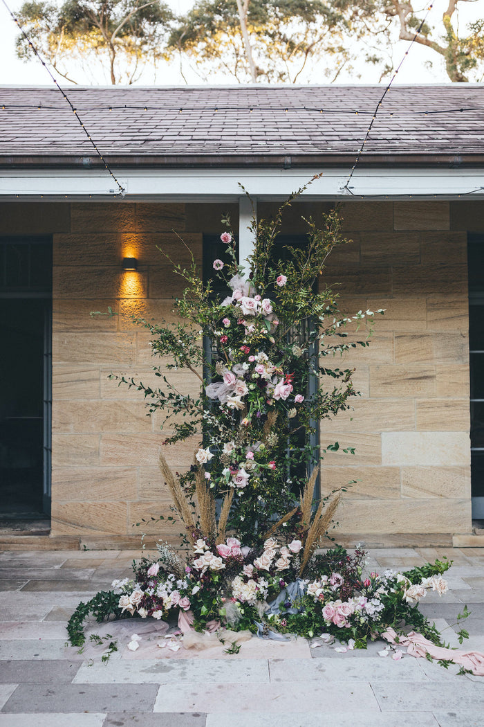Floral installation climbing the centre pole in the Sandstone Courtyard at Gunners Barracks