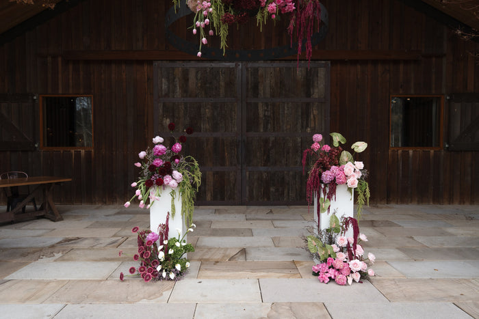 Ceremony plinths and a hanging floral hoop at The Stables, Bendooley Estate