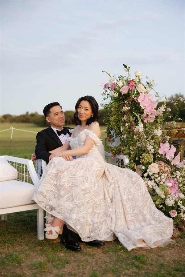 asian couple seated on the lawn at centennial park for wedding photography with flowers sydney