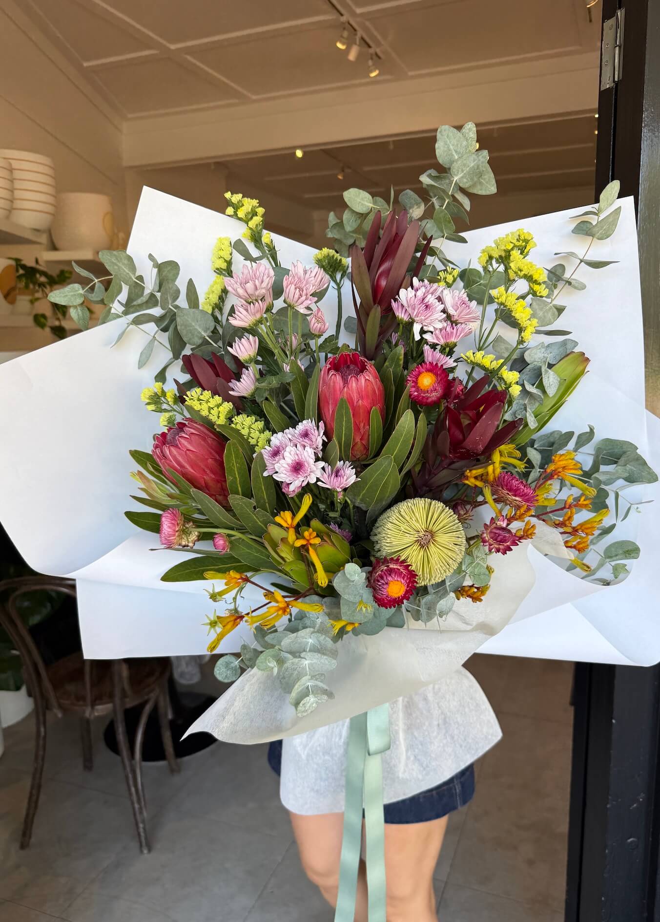 bouquet of native australian mothers day flowers with red protea statice leucadendrons and banksia paper daisy sydney delivery