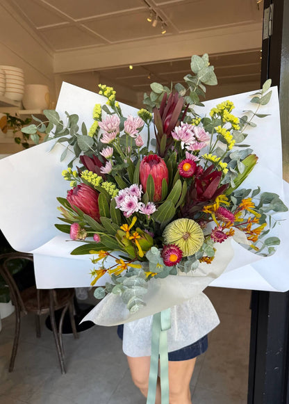 bouquet of native australian mothers day flowers with red protea statice leucadendrons and banksia paper daisy sydney delivery