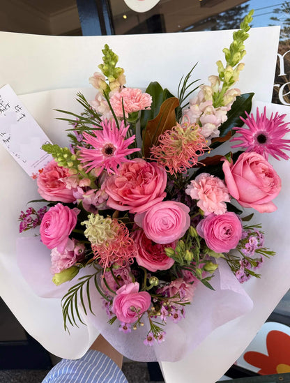 Bouquet of valentine romantic pink flowers with greenery on a white background