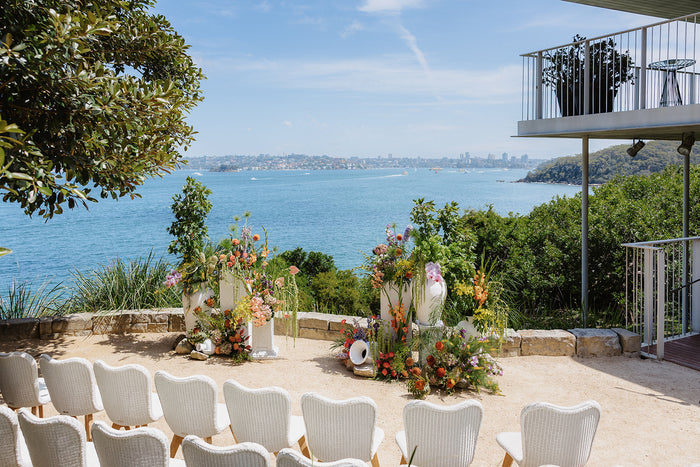 Harbour-view amphitheatre ceremony with floor arrangements at Sergeants Mess